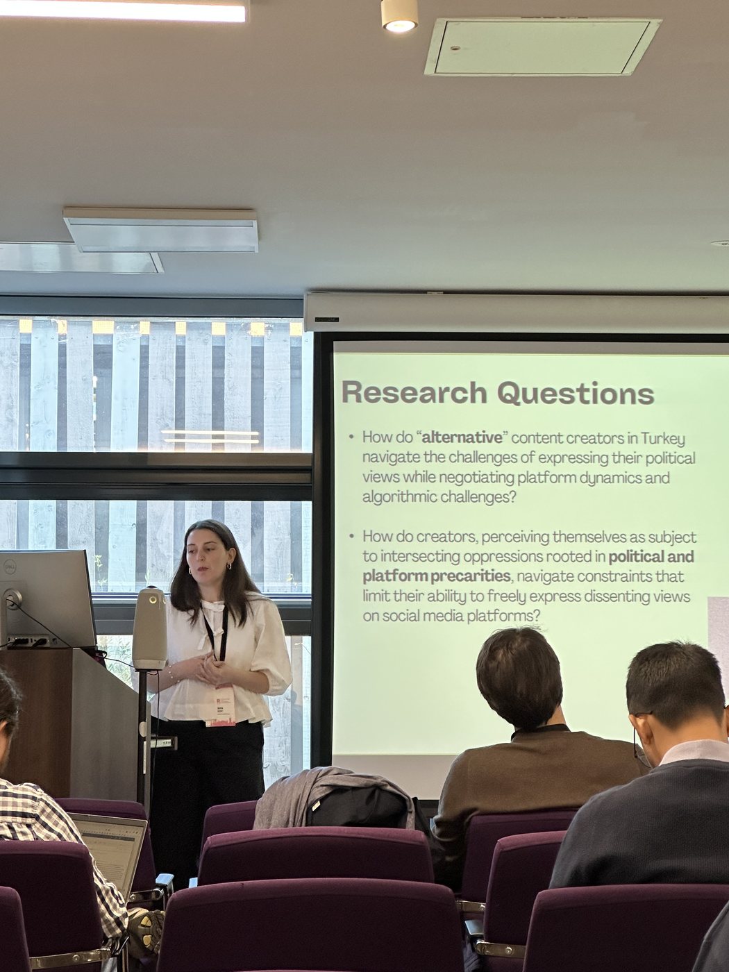 Nora Suren presenting research questions on alternative content creators in Turkey
