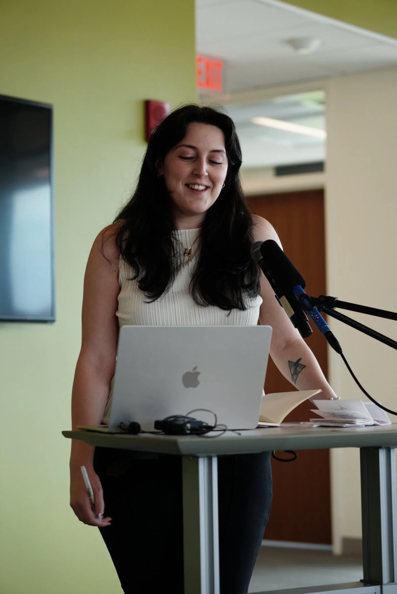 Nora Suren speaking at a podium